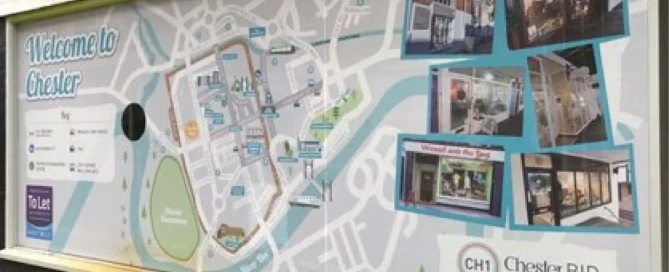 Chester tourist information board featuring a street map and local shop photography