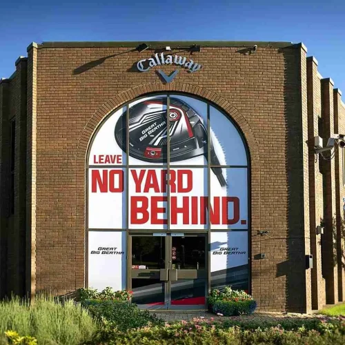 Callaway Golf office entrance featuring Great Big Bertha driver window graphics and Leave No Yard Behind slogan.