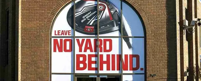 Callaway Golf office entrance featuring Great Big Bertha driver window graphics and Leave No Yard Behind slogan.