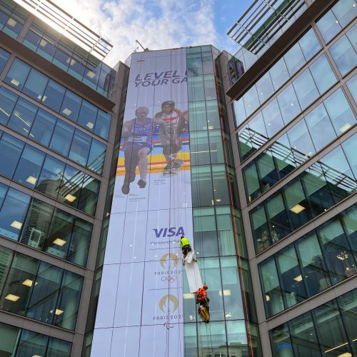 Advanced large-format adhesive graphic for building exterior surfaces.
