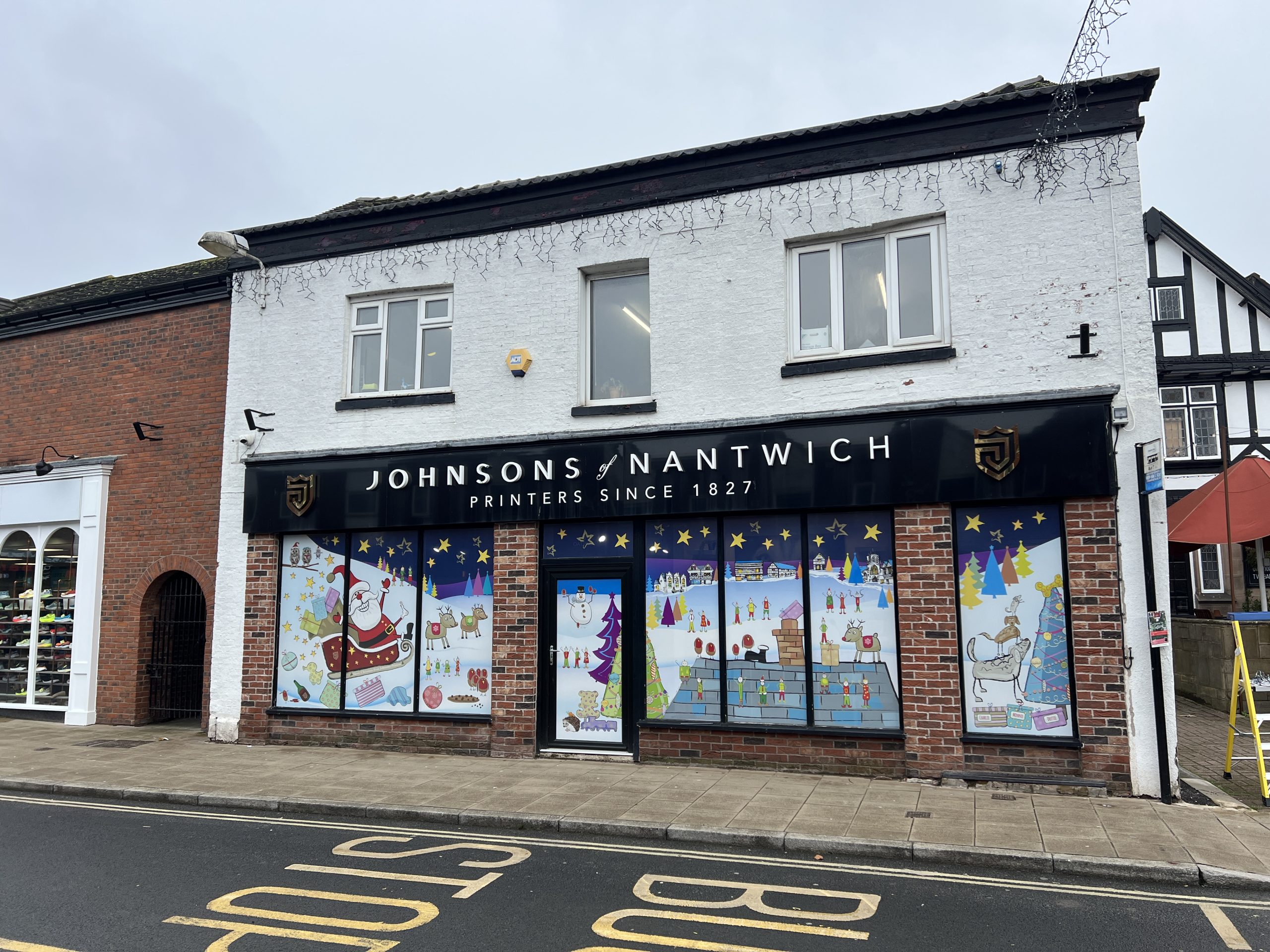 window-graphics-johnsons-nantwich-christmas-contravision Contra Vision one-way vision window filmSeasonal Window Graphic installation at Johnsons Printers Nantwich