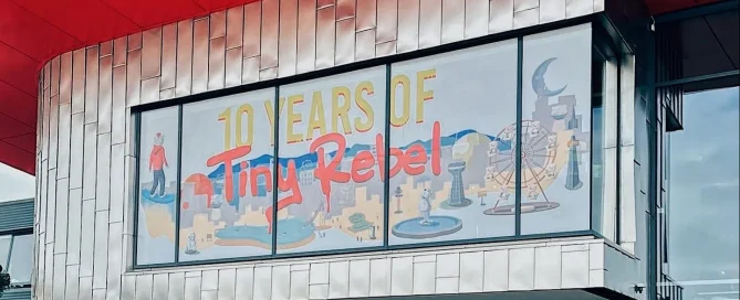 Tiny Rebel brewery building frontage featuring 10th anniversary graphic applied to glass using perforated window film.