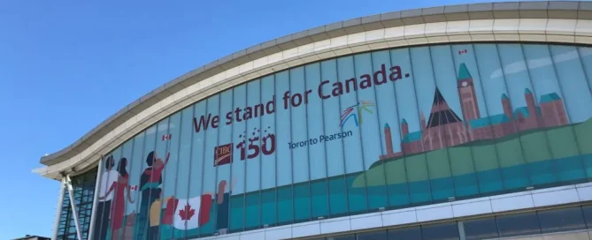 Toronto Pearson Airport exterior windows featuring a Canada 150 wrap with illustrations of the Canadian Parliament.