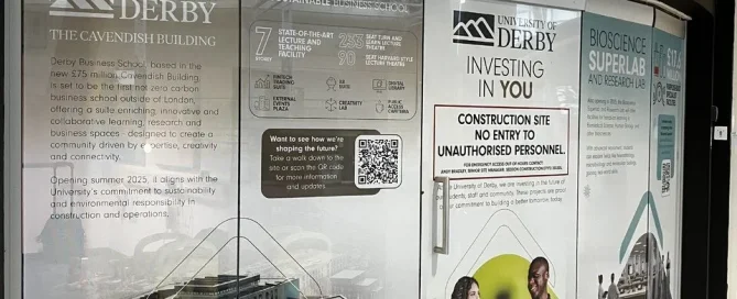 Window graphics on glass doors at the University of Derby Cavendish Building construction site.