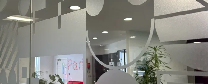 Frosted window film featuring geometric patterns on a glass office partition at Parker Design.